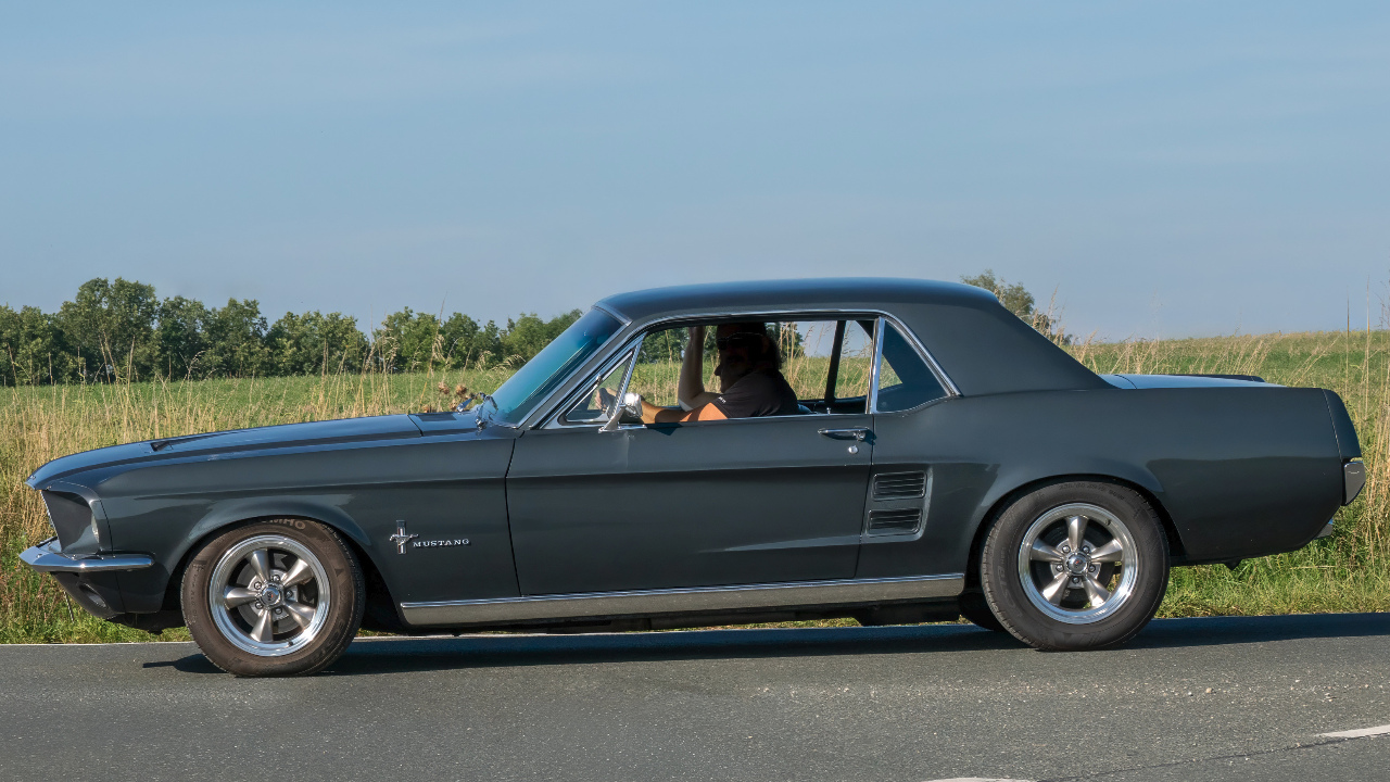 Side view of a 1968 Ford Mustang at the 7th US car meeting in Leimershof