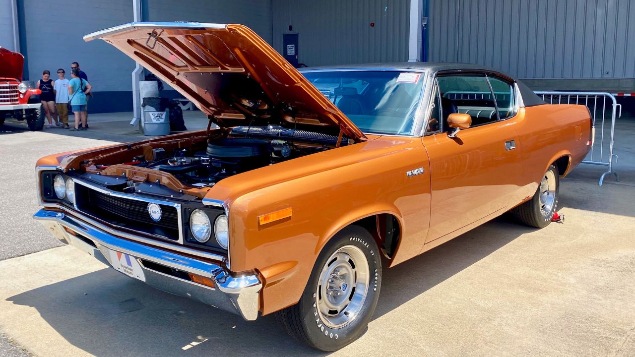1970 AMC Rebel Machine in Bittersweet Orange with black vinyl roof at 2024 AMO meet 01of13