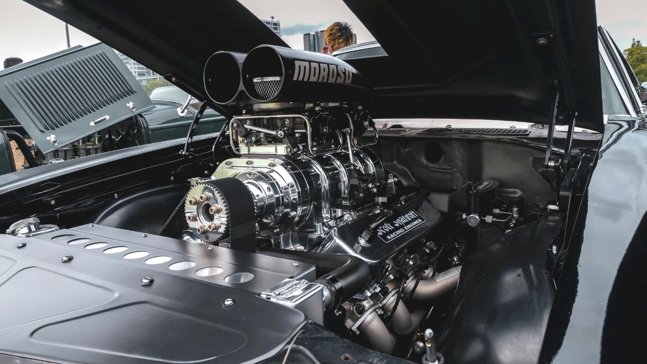 A black car with a large engine in the front