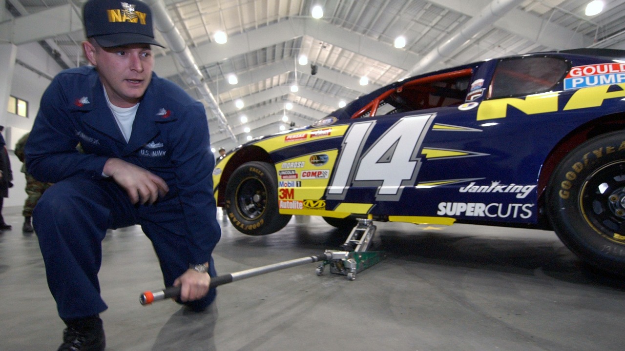 S Navy 040130-N-5576W-003 Recruit Division Commander (RDC) Hull Maintenance Technician 1st Class Duane Dominick practices being the jackman prior to the pit stop competition.