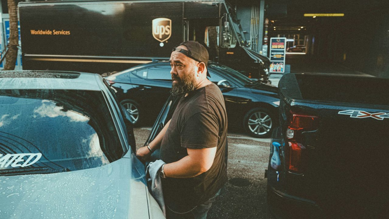 Baby Boomer Beside a Car