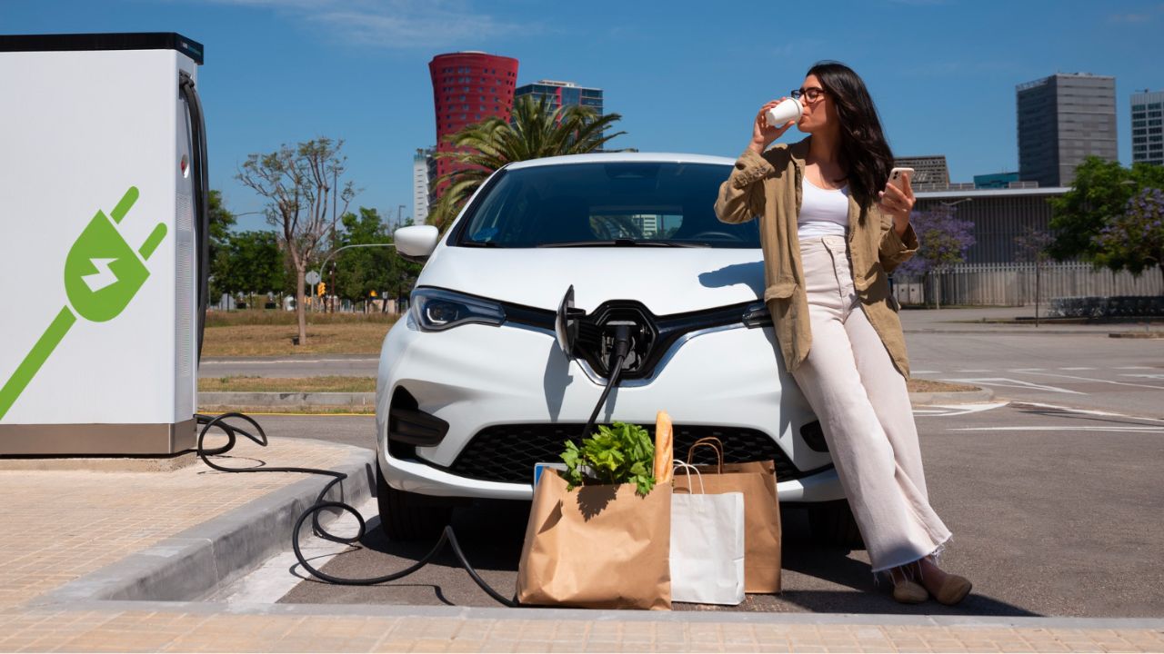 Car Charging and woman drinking coffee