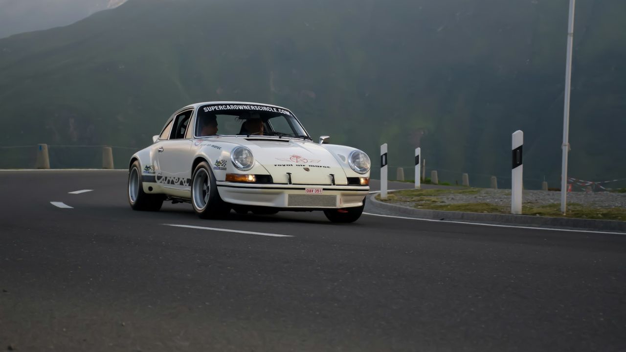 Classic Car Driving on Scenic Road
