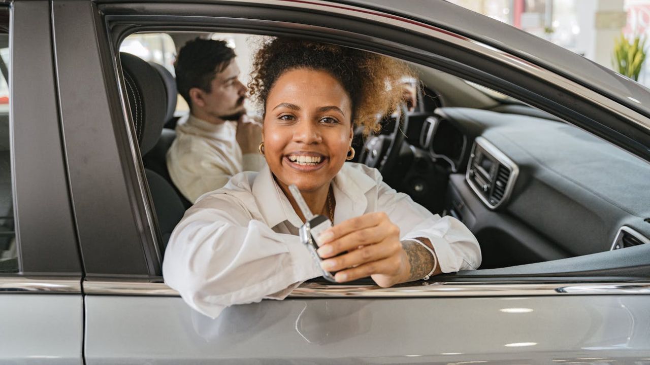 Smiling Woman Sitting in a New Car
