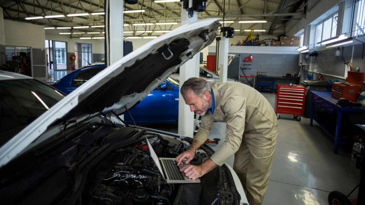 Workshop Mechanic Working on Laptop