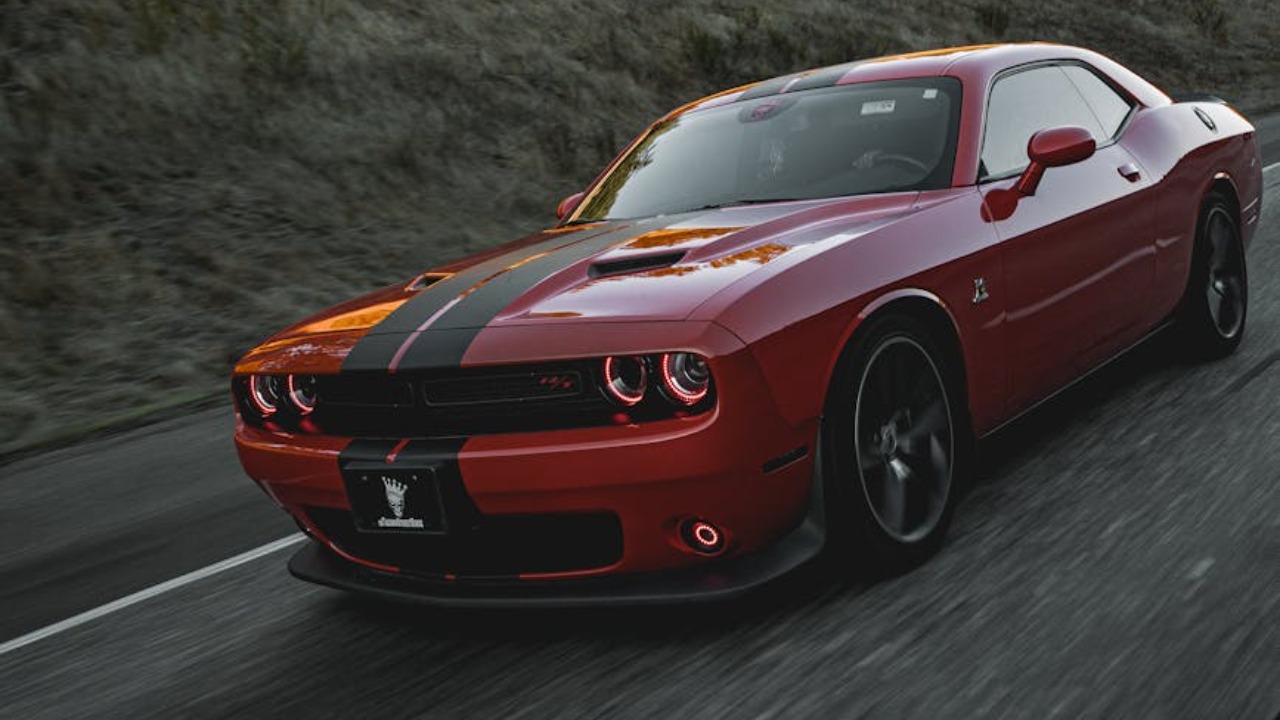 Dynamic capture of a red Dodge Challenger on a scenic highway in Lacey, Washington.
