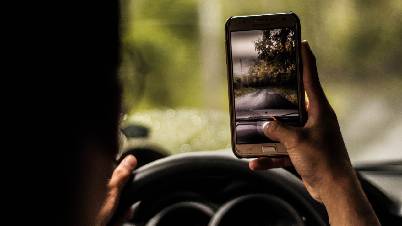 Cell phone use laws behind the wheel