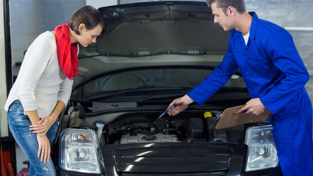 
Mechanic showing customer the problem with car