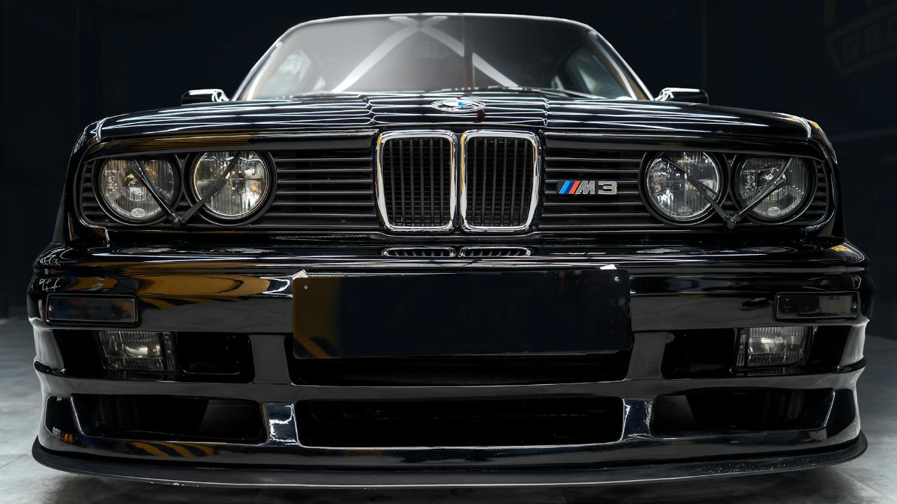 A classic BMW E30 M3 captured from the front, showcasing vintage design in Tehran.