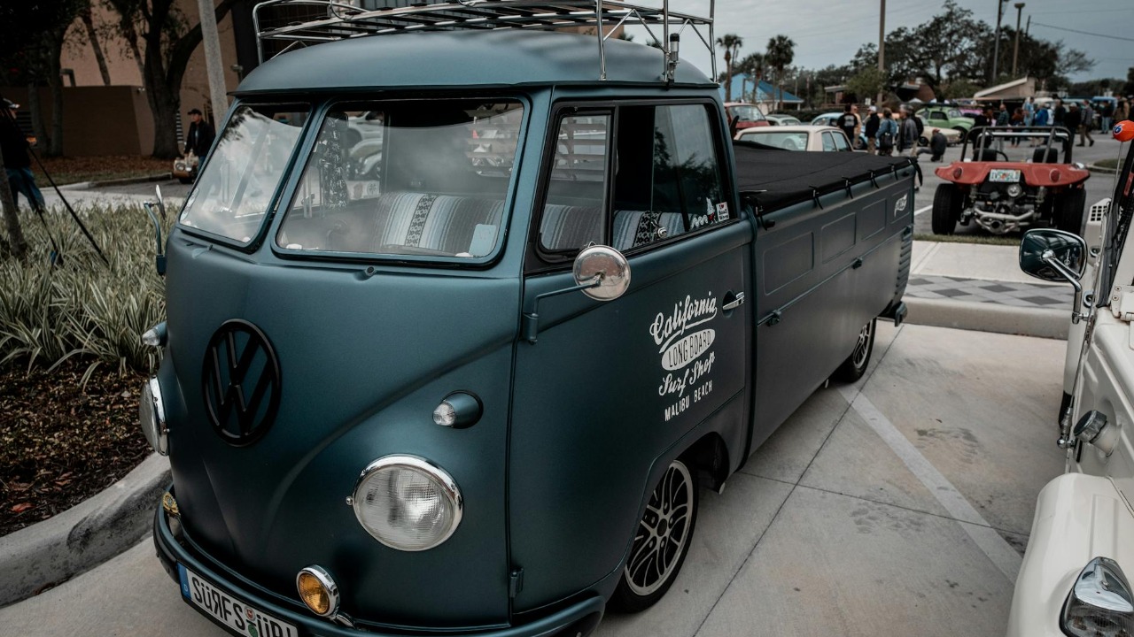 Classic Volkswagen pickup truck displayed at a car show, showcasing its vintage style.