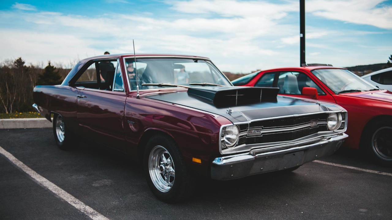 Classic Dodge Dart parked in a lot, showcasing vintage American automotive design.