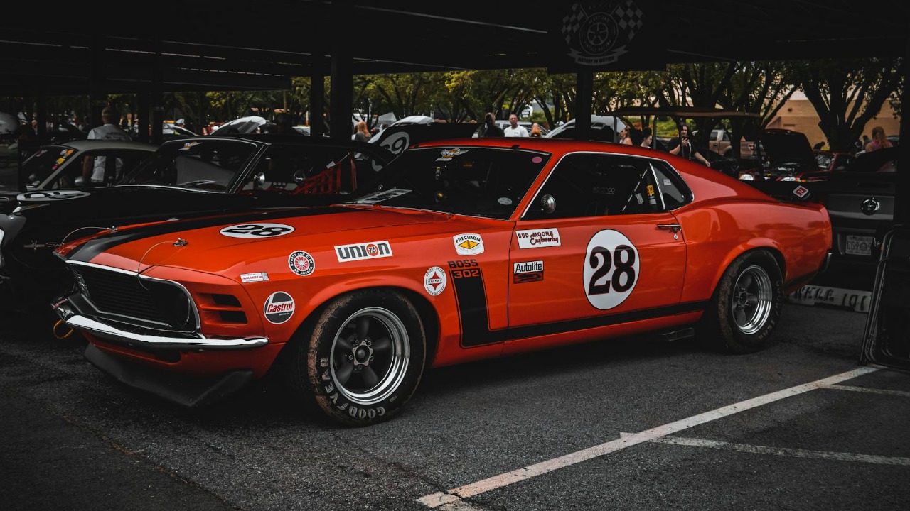 A classic red Ford Mustang racecar on display outdoors in Tulsa, Oklahoma.