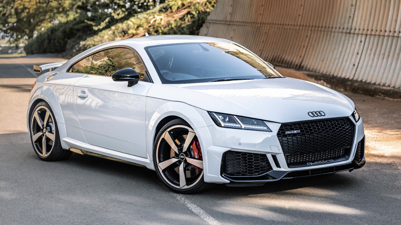 white audi r 8 parked near brown wall