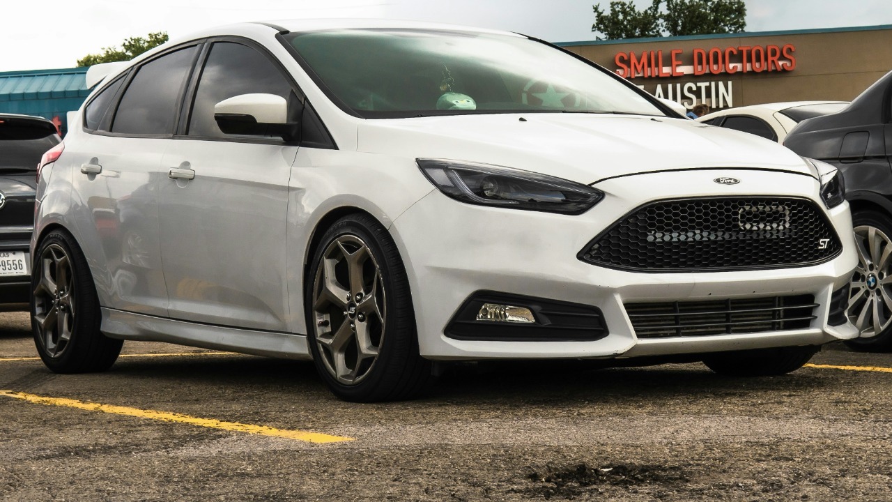 white honda sedan on parking lot during daytime