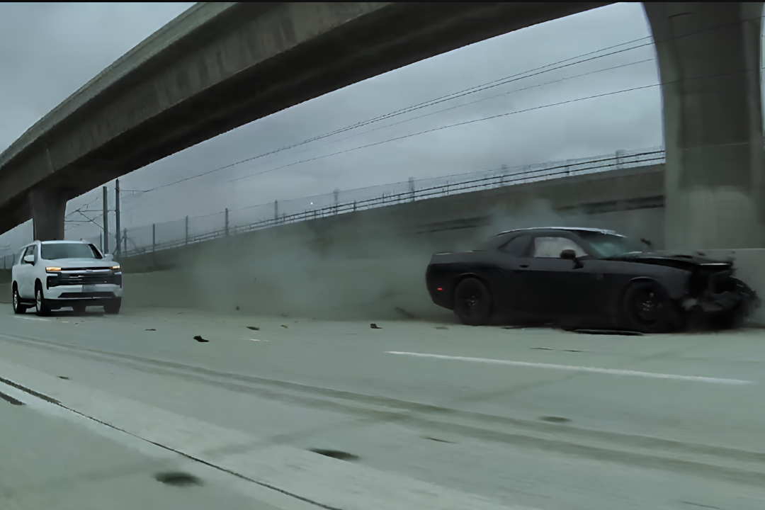 Dodge Challenger loses its mind and hits the wall after getting honked at by a Tesla