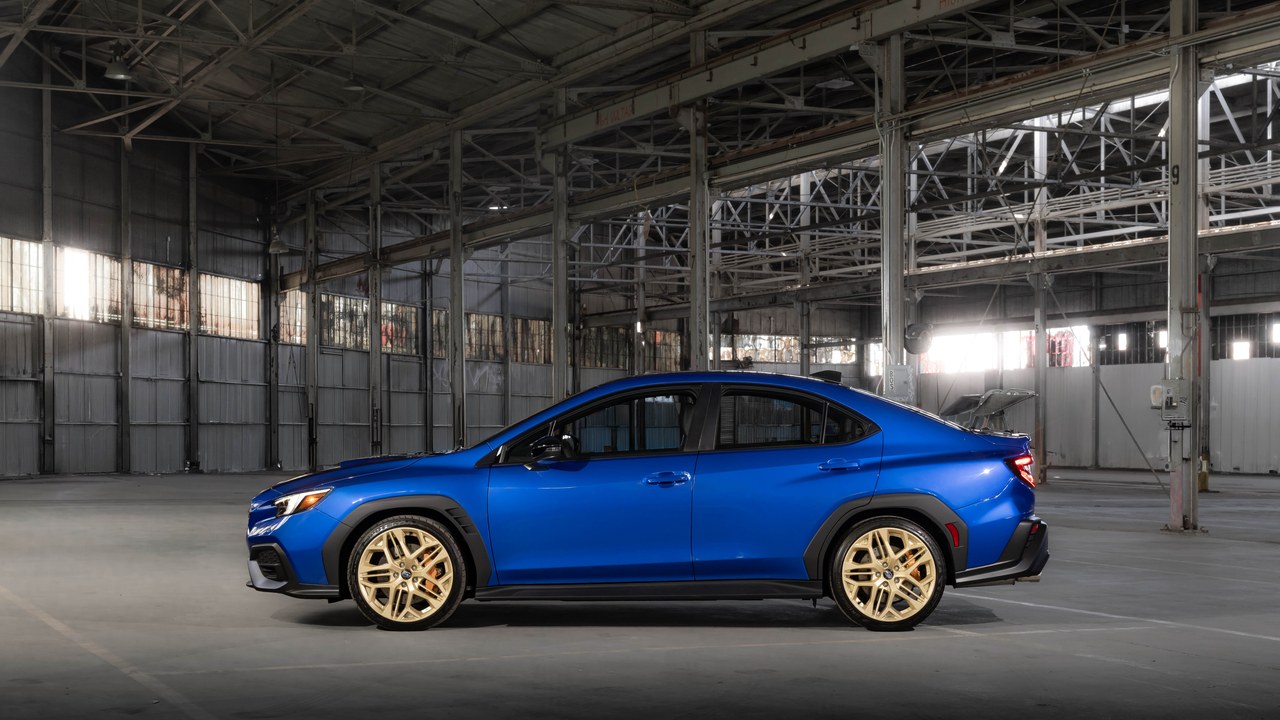 Side view of the 2027 Subaru WRX GD25 in World Rally Blue with gold wheels