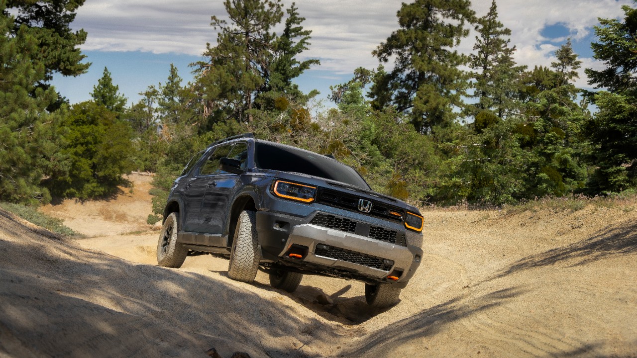 2027 Honda Passport TrailSport climbing a rocky trail