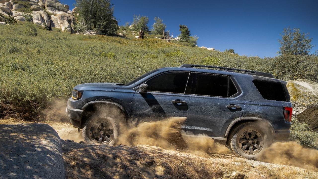 2027 Honda Passport TrailSport cresting a hill off-road