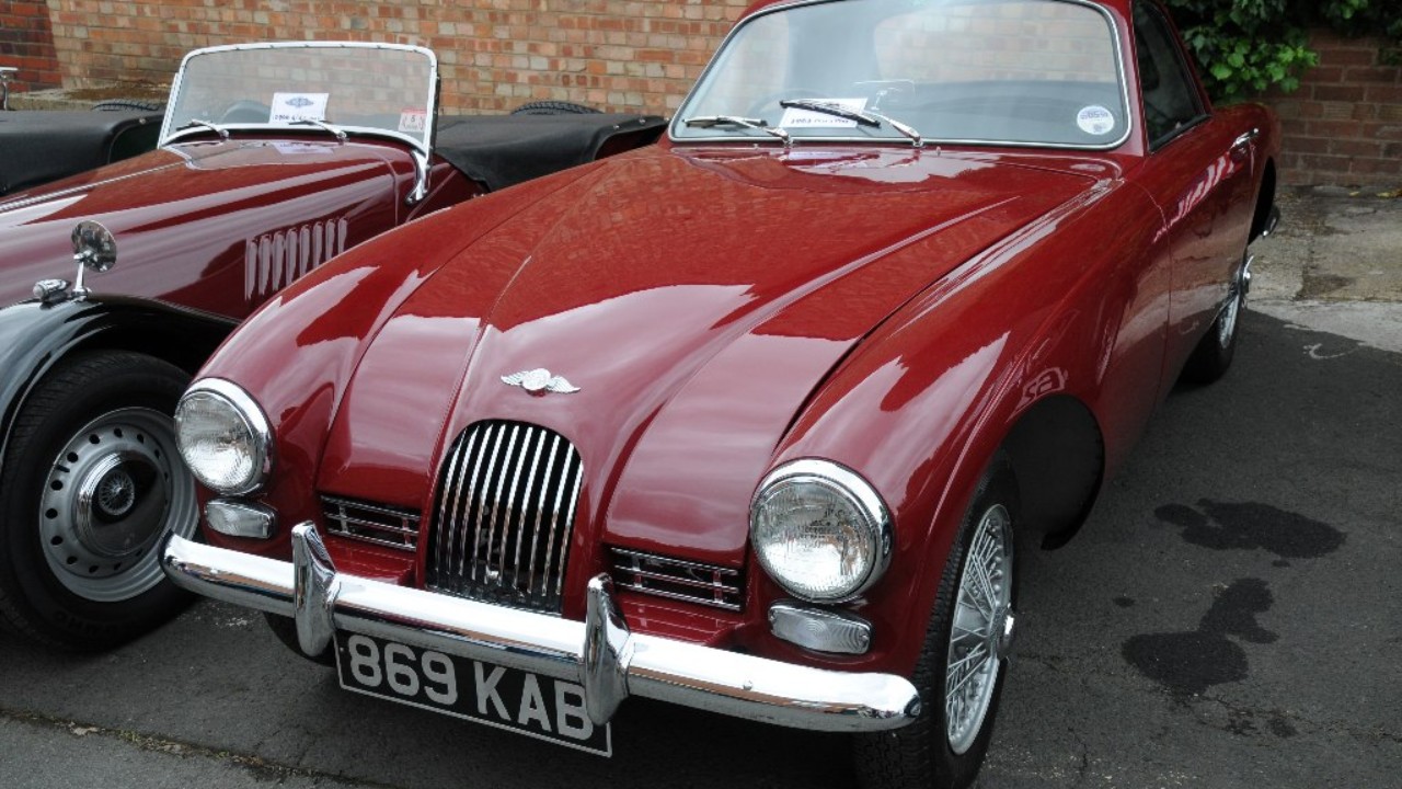 A red Morgan Plus 4 Plus coupe