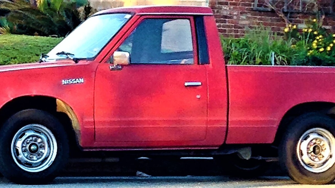 A red Datsun 720 pickup