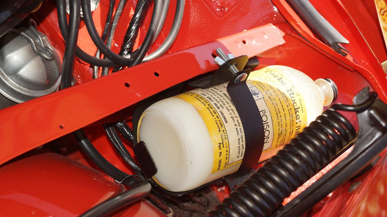 The Turbo-Rocket Fluid reservoir in a 1962 Oldsmobile Jetfire engine bay