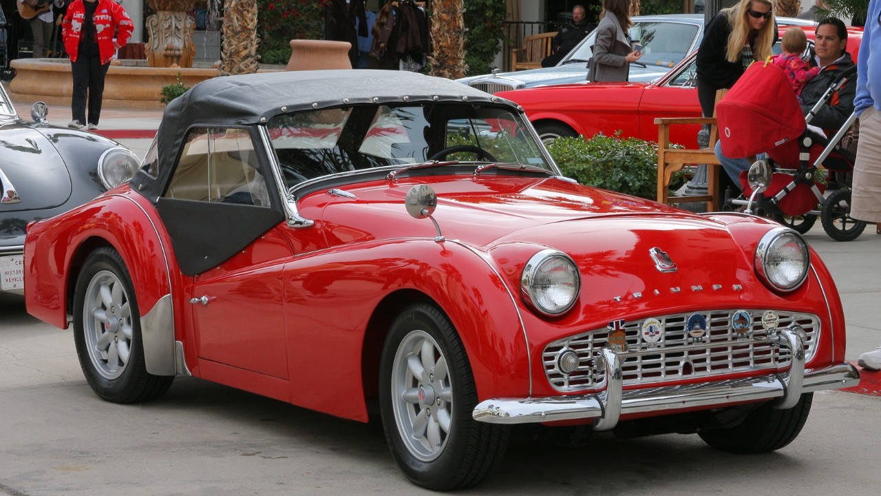 A red 1960 Triumph TR3A with its full-width grille
