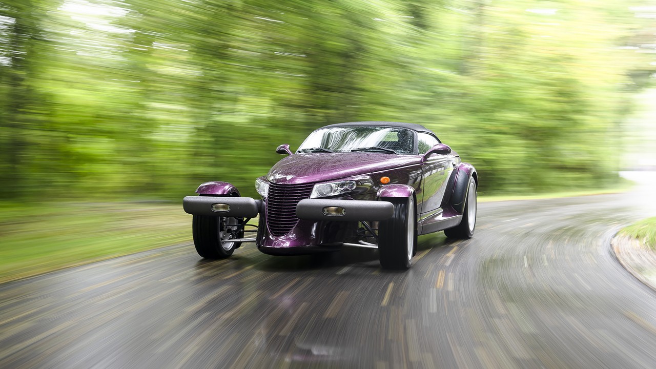 A 1997 Plymouth Prowler in Prowler Purple on a wet road