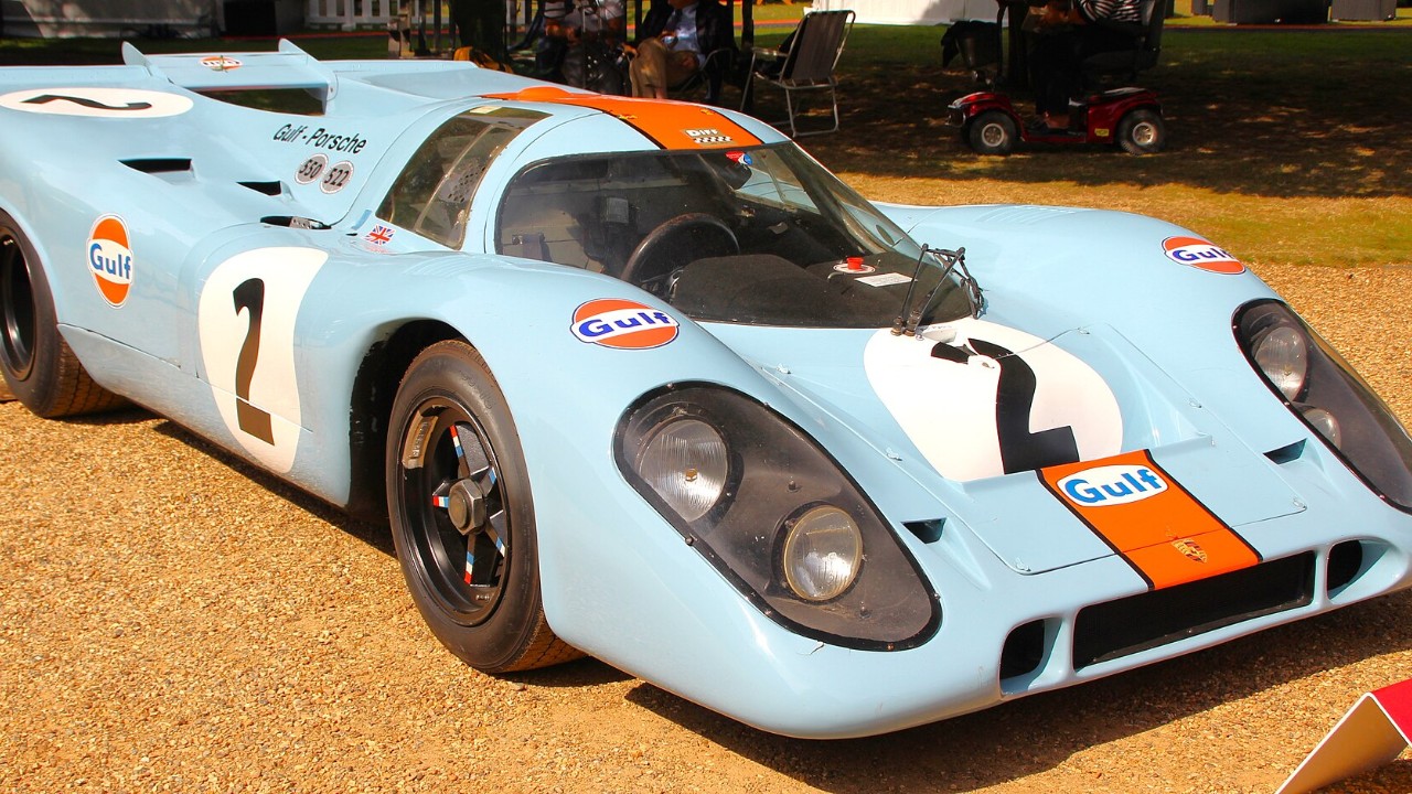 A Gulf-liveried Porsche 917K at a concours (same model as the event car)