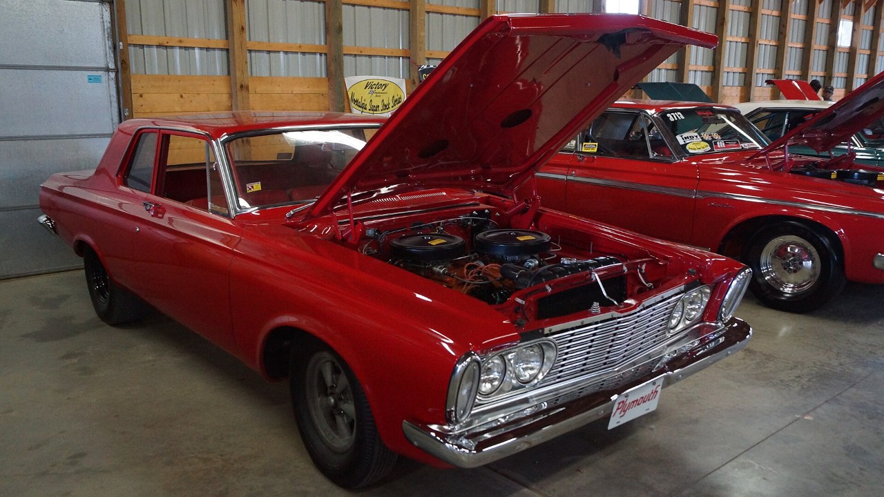A 1963 Plymouth Savoy Max Wedge with its hood open, from the 426 Wedge era