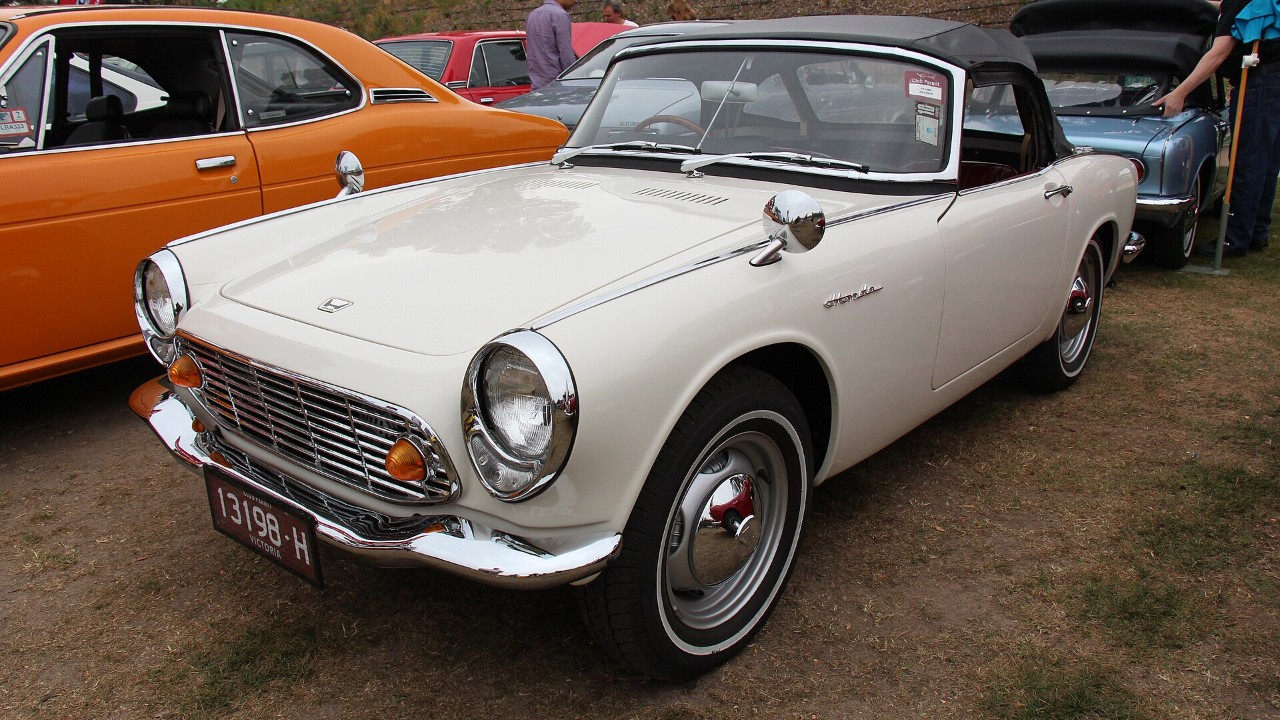 A white 1965 Honda S600 roadster