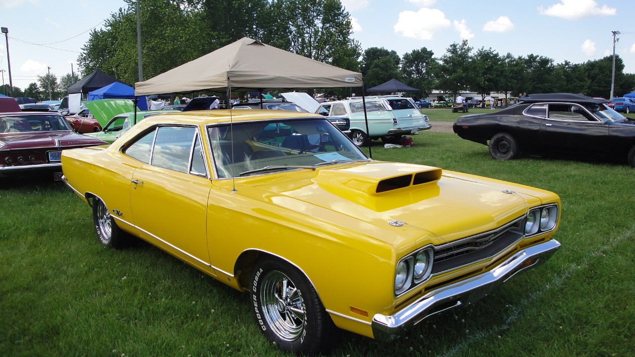 A yellow 1969 Plymouth GTX with its twin hood scoops