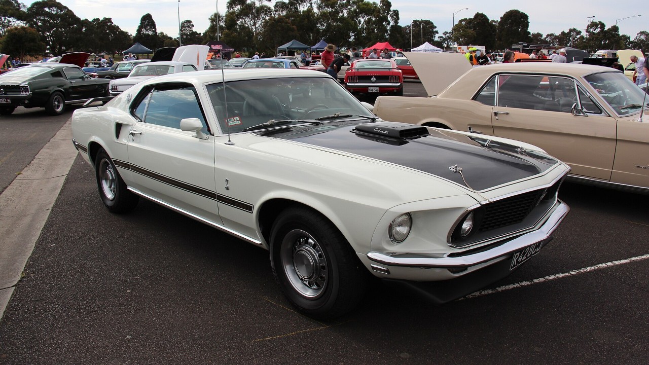 A white 1969 Ford Mustang Mach 1 428 Cobra Jet with the Shaker cold-air induction scoop