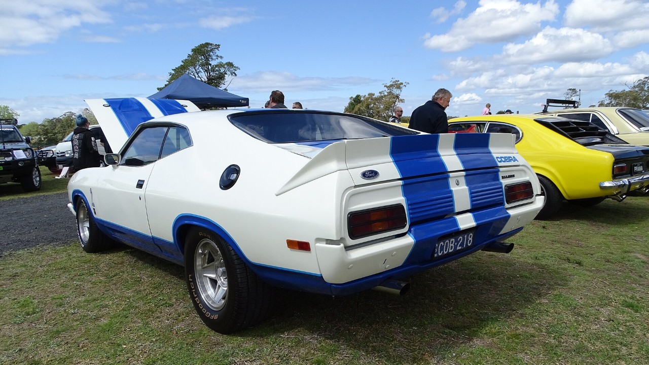A white Ford Falcon XC Cobra hardtop with blue stripes